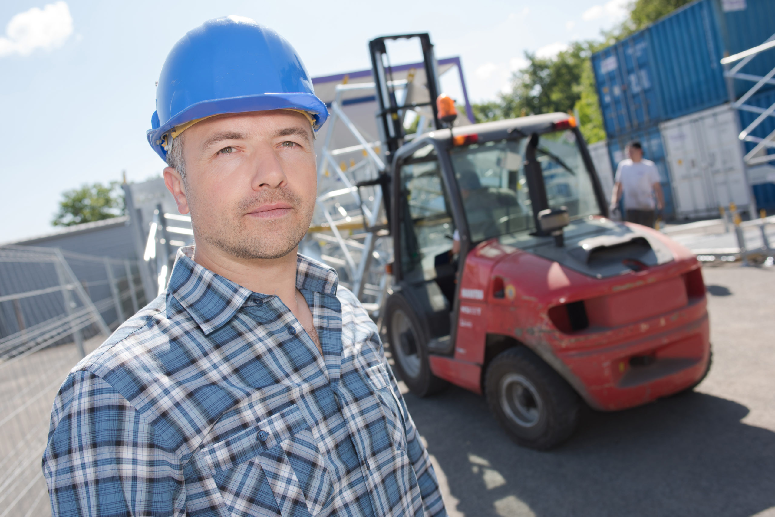 Portrait of man in front of forklift